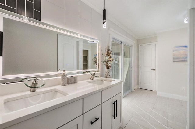 5744 150th Ave N, Clearwater, FL 33760 - bathroom featuring crown molding, double vanity, baseboards, and marble look tile flooring