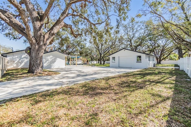 5744 150th Ave N, Clearwater, FL 33760 - view of yard with driveway and a garage