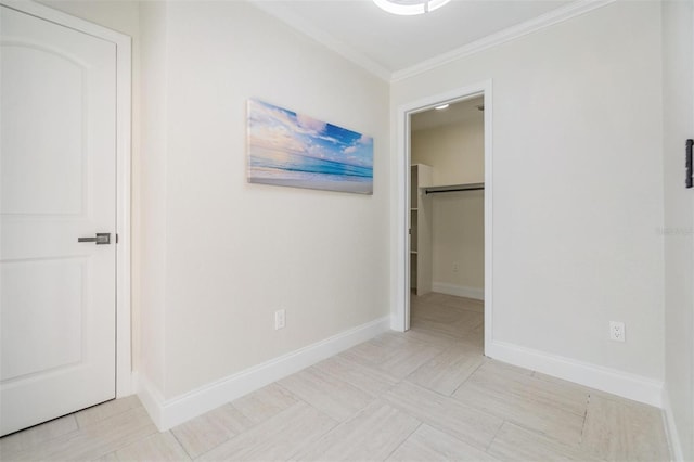 5744 150th Ave N, Clearwater, FL 33760 - unfurnished bedroom featuring ornamental molding, a walk in closet, baseboards, and a closet