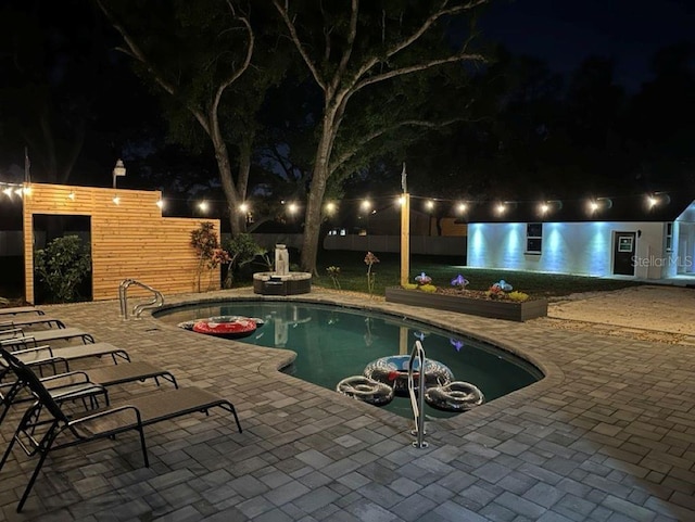 5744 150th Ave N, Clearwater, FL 33760 - pool at night featuring a patio area and an outdoor pool