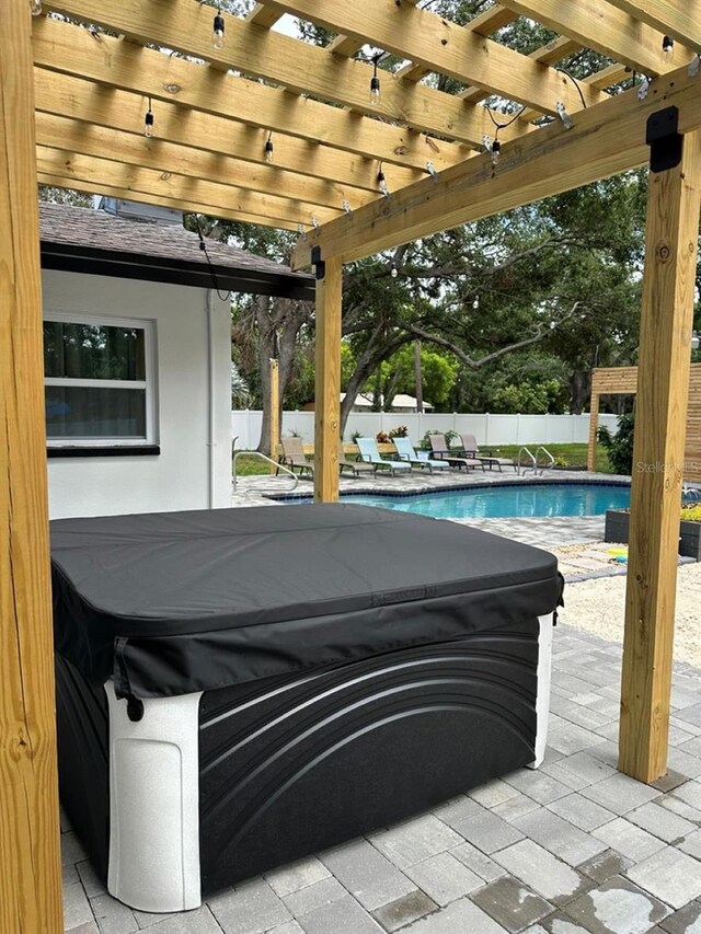 5744 150th Ave N, Clearwater, FL 33760 - fenced backyard with a hot tub, a pergola, and a patio