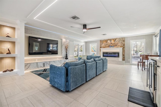 5744 150th Ave N, Clearwater, FL 33760 - living area with ceiling fan, a stone fireplace, crown molding, and built in features