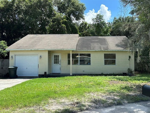 view of front of house with a garage, a front yard, and concrete driveway