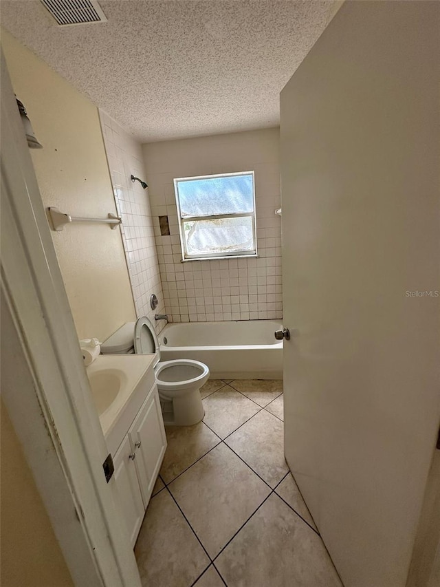 full bath featuring a textured ceiling, toilet, tub / shower combination, tile patterned flooring, and vanity