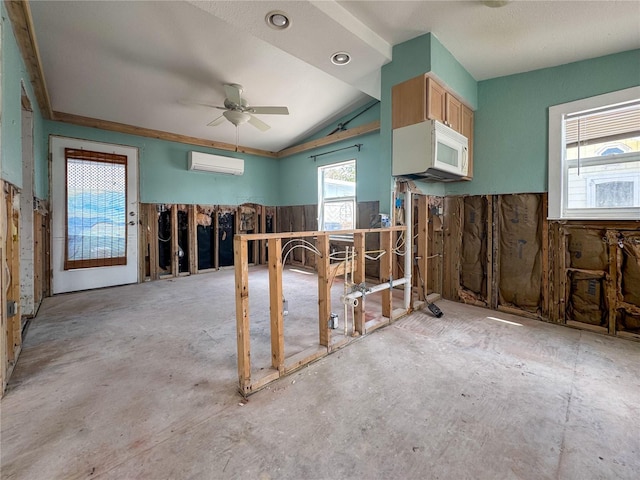 13326 1st St E, Madeira Beach, FL 33708 - interior space featuring an AC wall unit, a ceiling fan, white microwave, and vaulted ceiling