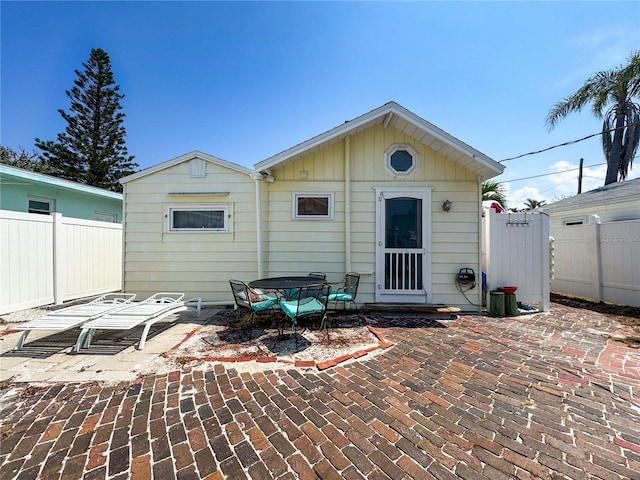 13326 1st St E, Madeira Beach, FL 33708 - back of house featuring a patio area, fence, and board and batten siding
