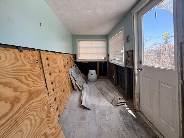 13326 1st St E, Madeira Beach, FL 33708 - washroom featuring wood finished floors and wainscoting