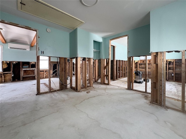 13326 1st St E, Madeira Beach, FL 33708 - miscellaneous room with attic access, an AC wall unit, and unfinished concrete floors