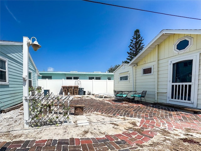 13326 1st St E, Madeira Beach, FL 33708 - rear view of property with a patio area and fence