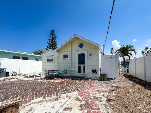 13326 1st St E, Madeira Beach, FL 33708 - rear view of property featuring fence and a patio