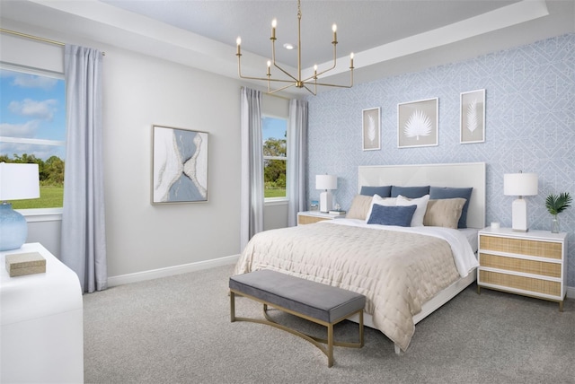 carpeted bedroom featuring a chandelier and baseboards