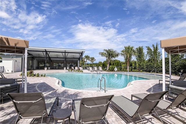 community pool featuring a patio area and fence
