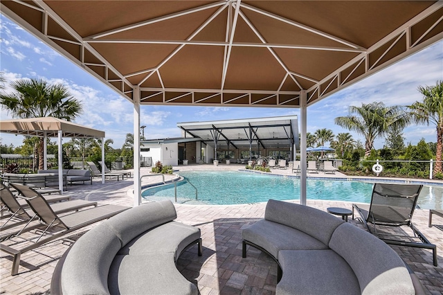 community pool featuring a gazebo, a patio, and outdoor lounge area
