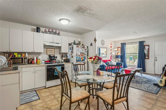 1250/1252/1254 Sylvia Ave, Spring Hill, FL 34606 - kitchen featuring white appliances, under cabinet range hood, light countertops, white cabinets, and a textured ceiling