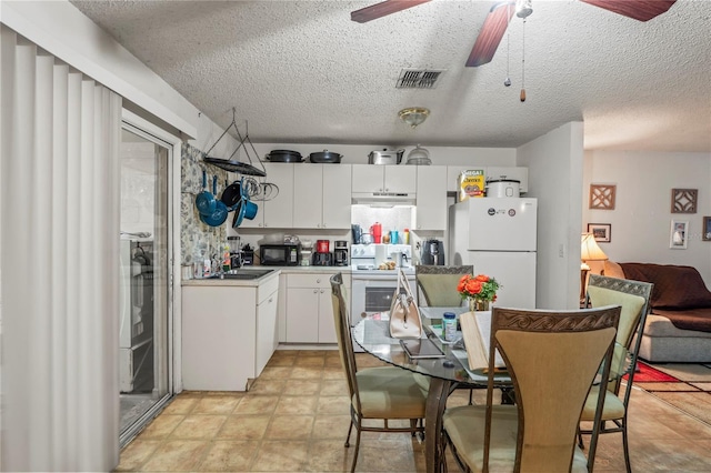 1250/1252/1254 Sylvia Ave, Spring Hill, FL 34606 - kitchen with white appliances, a ceiling fan, white cabinets, a textured ceiling, and a sink