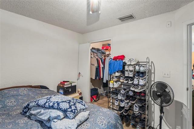 1250/1252/1254 Sylvia Ave, Spring Hill, FL 34606 - tiled bedroom featuring a textured ceiling, a spacious closet, a closet, and ceiling fan
