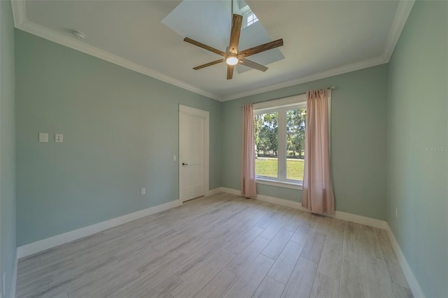 spare room featuring light wood finished floors, baseboards, ceiling fan, ornamental molding, and a smoke detector