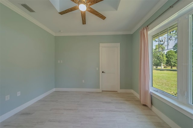 spare room featuring ceiling fan, ornamental molding, and baseboards