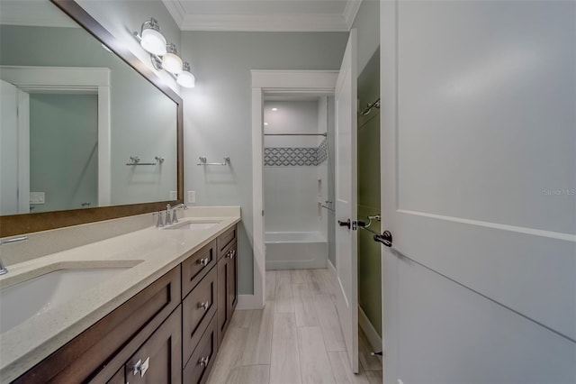 bathroom with ornamental molding, double vanity, shower / washtub combination, and baseboards