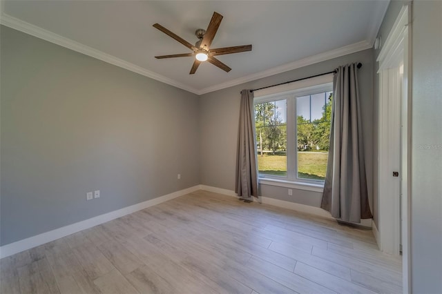 empty room featuring ceiling fan, crown molding, light wood-style flooring, and baseboards