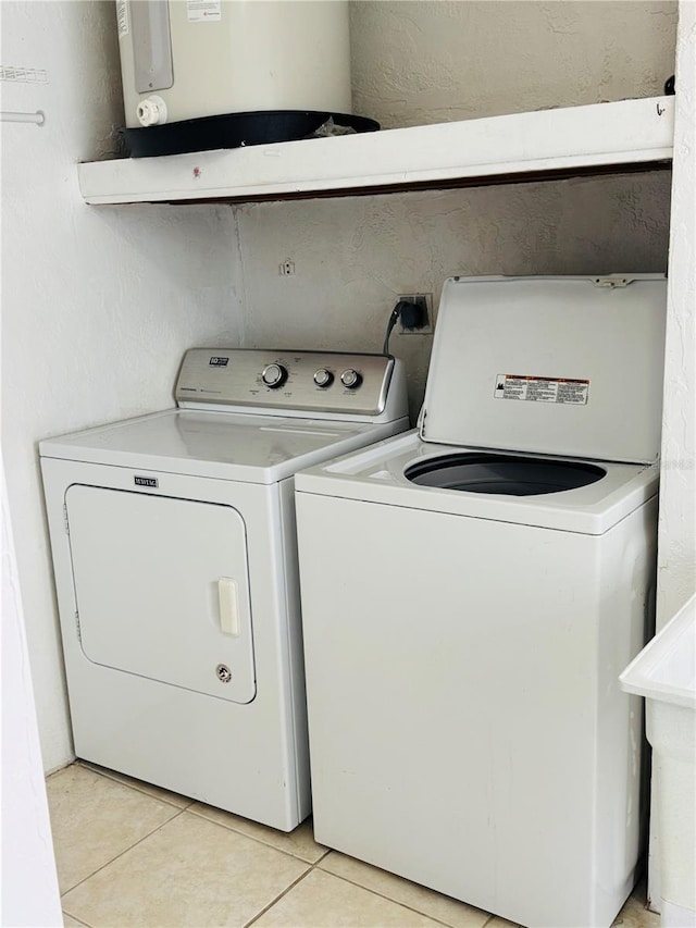 821 Karen St, Palm Harbor, FL 34684 - washroom featuring light tile patterned flooring, water heater, and washer and dryer