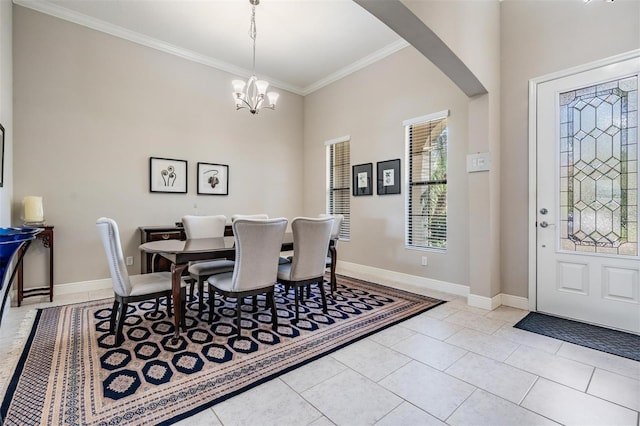 32242 Summerglade Dr, Wesley Chapel, FL 33545 - dining space with crown molding, arched walkways, a chandelier, light tile patterned floors, and baseboards