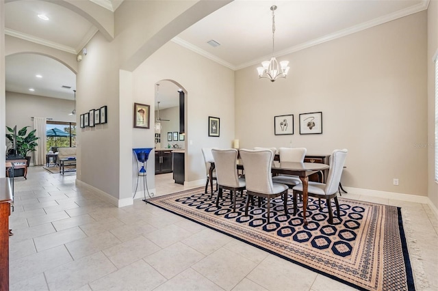 32242 Summerglade Dr, Wesley Chapel, FL 33545 - dining area featuring ornamental molding, arched walkways, baseboards, a chandelier, and light tile patterned floors