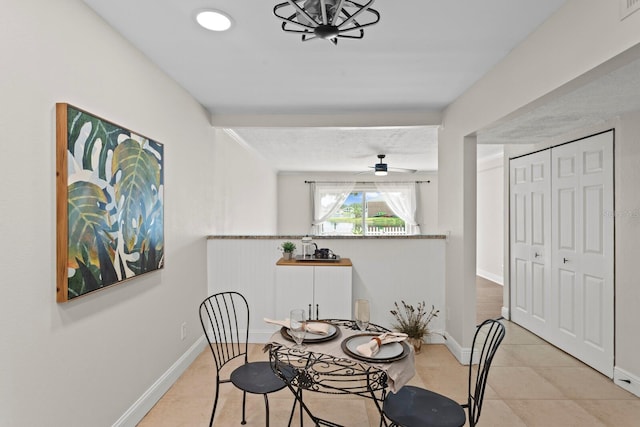 dining area with tile patterned flooring, baseboards, and ceiling fan