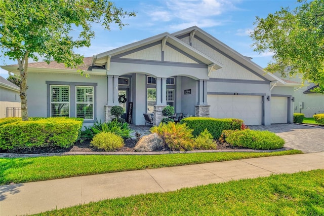 4093 Epic Cv, Land O Lakes, FL 34638 - craftsman inspired home with an attached garage, decorative driveway, stucco siding, and a porch