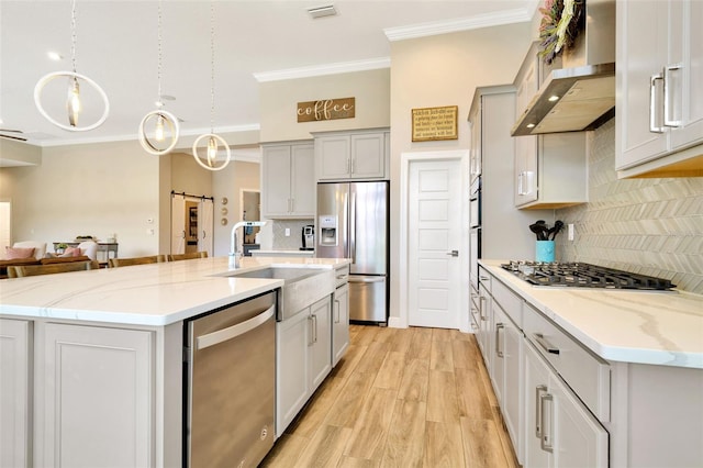 4093 Epic Cv, Land O Lakes, FL 34638 - kitchen with stainless steel appliances, a sink, ornamental molding, wall chimney exhaust hood, and tasteful backsplash