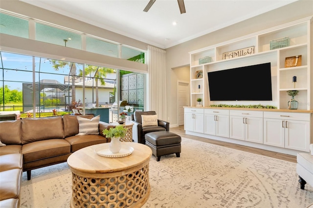 4093 Epic Cv, Land O Lakes, FL 34638 - living room featuring a ceiling fan, ornamental molding, light wood-style floors, recessed lighting, and built in shelves