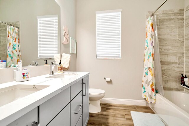 4093 Epic Cv, Land O Lakes, FL 34638 - full bath featuring shower / bath combo, plenty of natural light, wood finished floors, and toilet