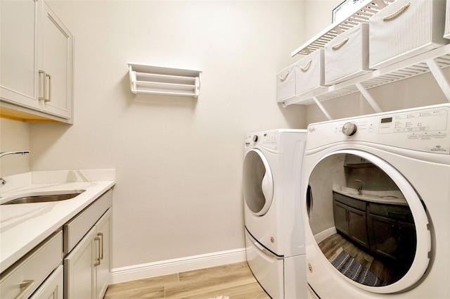 4093 Epic Cv, Land O Lakes, FL 34638 - washroom with independent washer and dryer, light wood finished floors, baseboards, and cabinet space