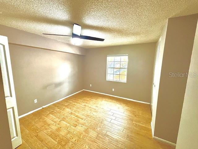 296 Lewfield Cir, Winter Park, FL 32792 - unfurnished room featuring a textured ceiling, light wood-style floors, and baseboards