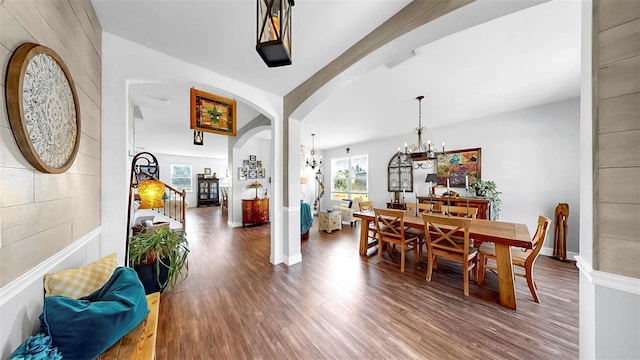 5040 Inshore Landing Dr, Apollo Beach, FL 33572 - dining room with a chandelier, wood finished floors, arched walkways, and baseboards