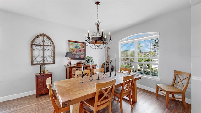 5040 Inshore Landing Dr, Apollo Beach, FL 33572 - dining room with a chandelier, wood finished floors, and baseboards