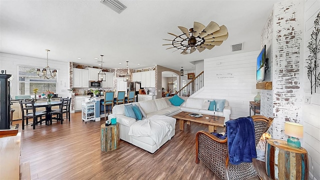 5040 Inshore Landing Dr, Apollo Beach, FL 33572 - living area with wood finished floors, a ceiling fan, stairway, and arched walkways
