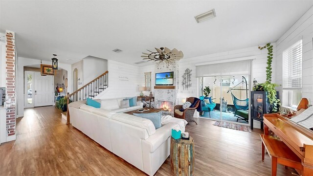 5040 Inshore Landing Dr, Apollo Beach, FL 33572 - living room with wood finished floors, stairway, and arched walkways