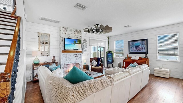 5040 Inshore Landing Dr, Apollo Beach, FL 33572 - living room with wood finished floors, stairs, and wood walls
