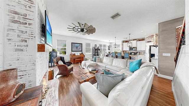 5040 Inshore Landing Dr, Apollo Beach, FL 33572 - living room featuring wood finished floors, ceiling fan, a fireplace, and recessed lighting