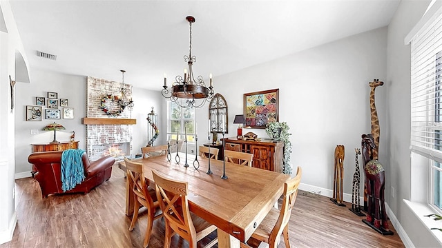 5040 Inshore Landing Dr, Apollo Beach, FL 33572 - dining space featuring wood finished floors, plenty of natural light, baseboards, and a chandelier