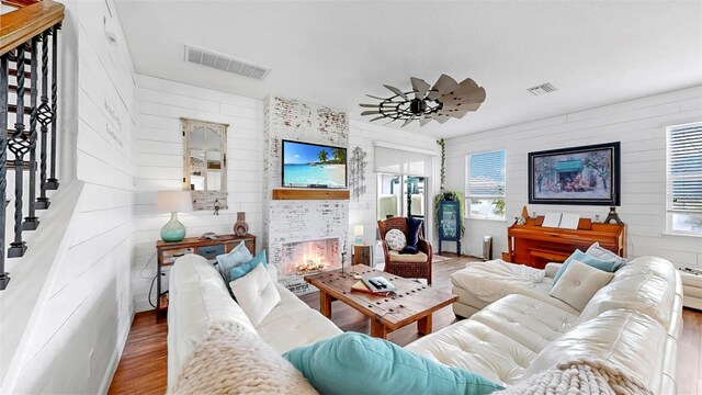 5040 Inshore Landing Dr, Apollo Beach, FL 33572 - living area featuring wood finished floors, healthy amount of natural light, wooden walls, and stairway