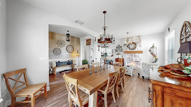 5040 Inshore Landing Dr, Apollo Beach, FL 33572 - dining room with arched walkways, light wood finished floors, and a chandelier