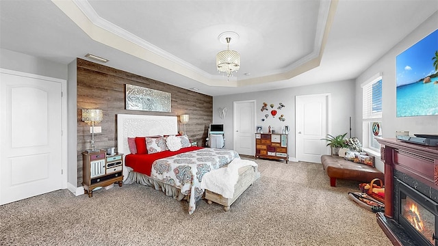 5040 Inshore Landing Dr, Apollo Beach, FL 33572 - bedroom with a tray ceiling, carpet flooring, a chandelier, and a glass covered fireplace