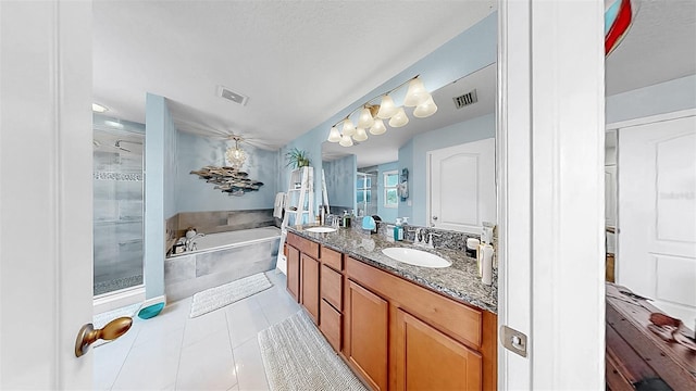 5040 Inshore Landing Dr, Apollo Beach, FL 33572 - bathroom featuring a stall shower, double vanity, a bath, and tile patterned flooring