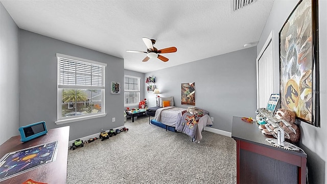 5040 Inshore Landing Dr, Apollo Beach, FL 33572 - bedroom featuring carpet flooring, baseboards, a textured ceiling, and a ceiling fan