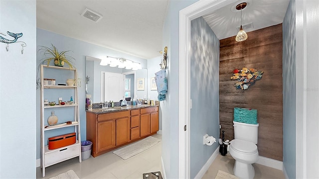 5040 Inshore Landing Dr, Apollo Beach, FL 33572 - bathroom with toilet, double vanity, tile patterned flooring, and baseboards
