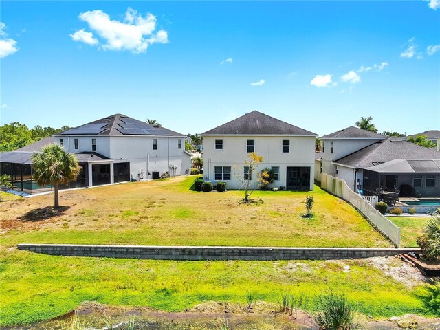 5040 Inshore Landing Dr, Apollo Beach, FL 33572 - back of house featuring stucco siding and a lawn