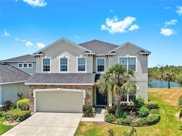 5040 Inshore Landing Dr, Apollo Beach, FL 33572 - view of front of property featuring stone siding, driveway, stucco siding, and a shingled roof