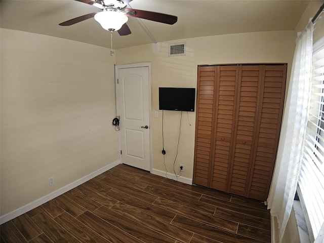10003 Winding Lake Rd Unit 105, Sunrise, FL 33351 - unfurnished bedroom featuring dark wood-type flooring, a closet, baseboards, and ceiling fan